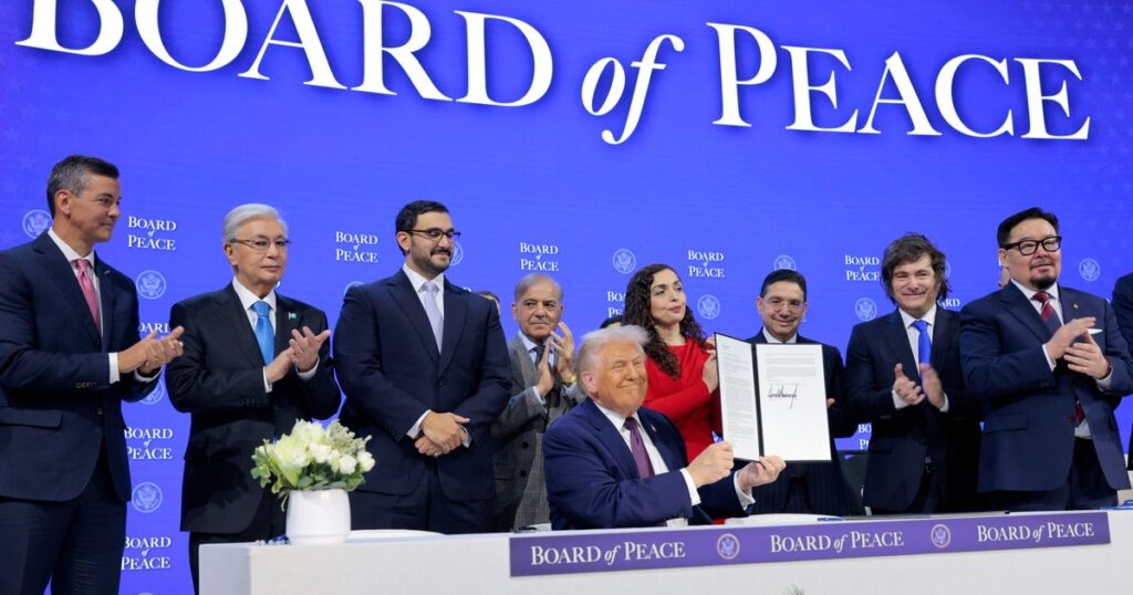Trump and “Board of Peace” partners sign founding charter in Davos, as he pledges group will work with U.N.
